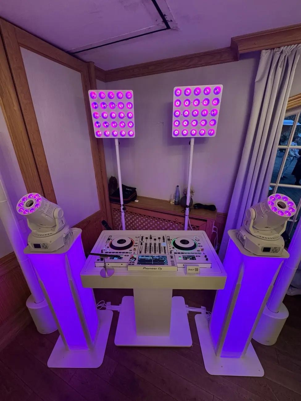 Elegantes weißes DJ-Setup mit violetter Beleuchtung